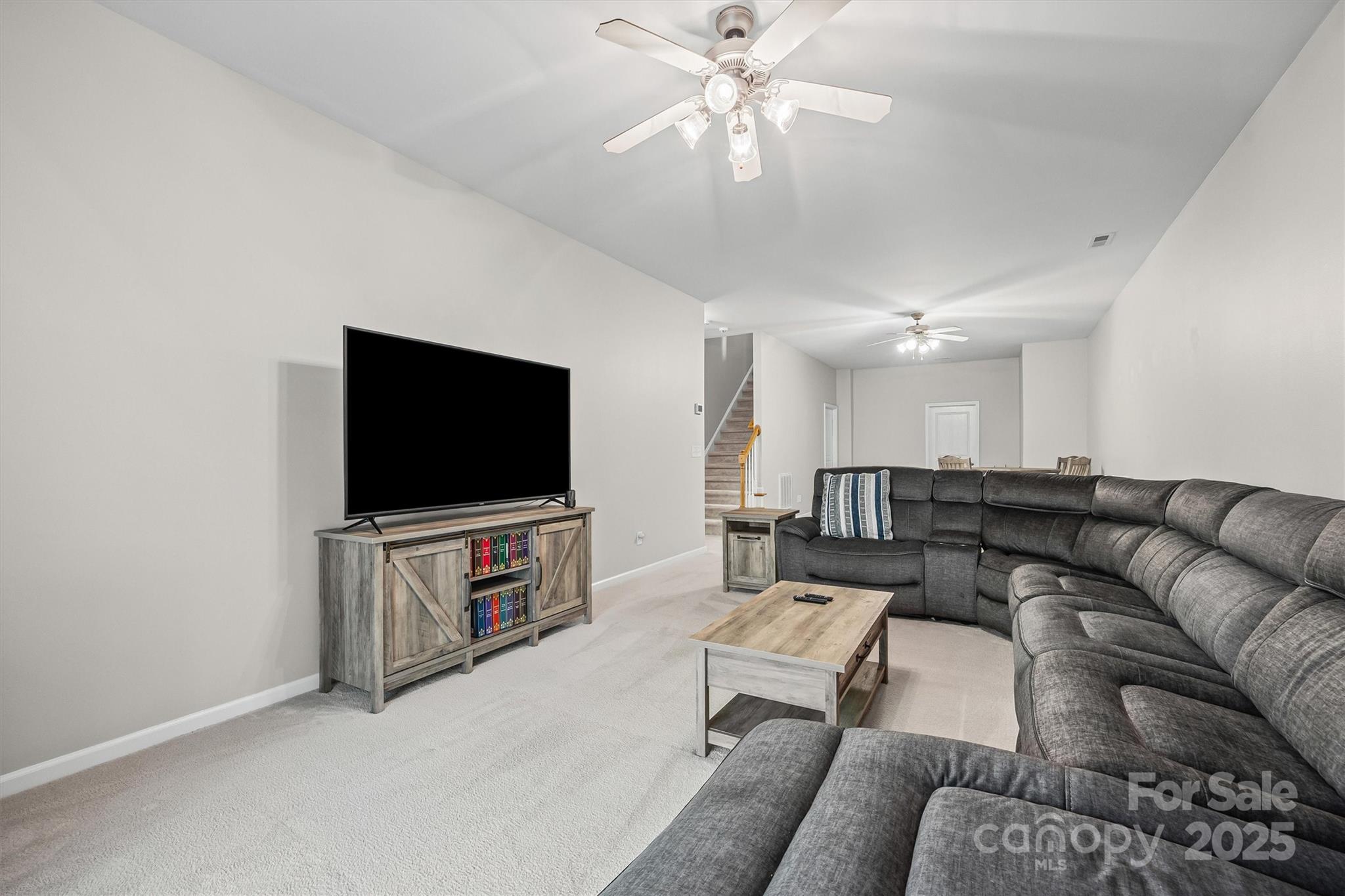 2090 Calloway Pines Drive Tega Cay, SC 29708 - Photo 20 of 38 a living room with furniture and a flat screen tv