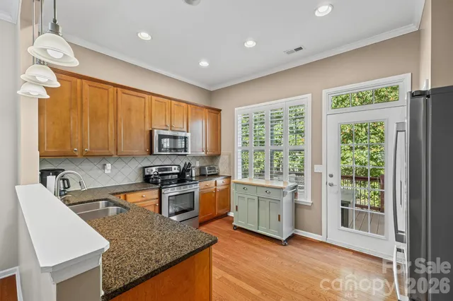 a kitchen with a stove a sink and a refrigerator
