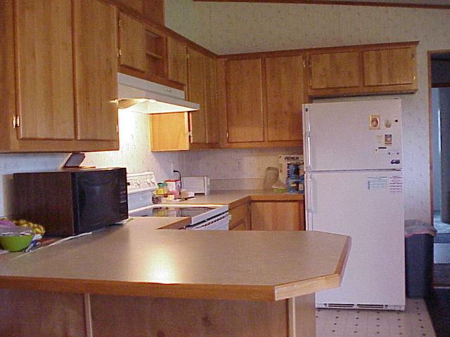 5003 Beam Road Granger, WA 98932 - Photo 8 of 14 a kitchen with kitchen island a sink a stove and a refrigerator