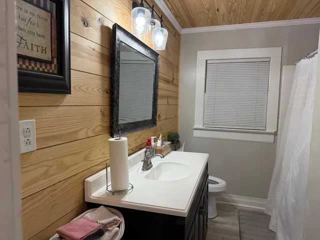 a bathroom with a sink vanity and a mirror