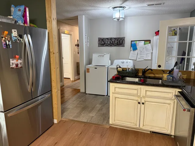 a kitchen with stainless steel appliances a refrigerator and a stove top oven
