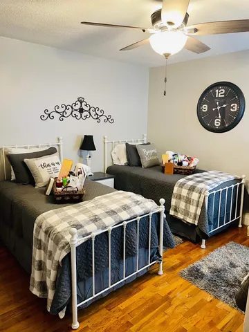 a bedroom with bed and wooden floor