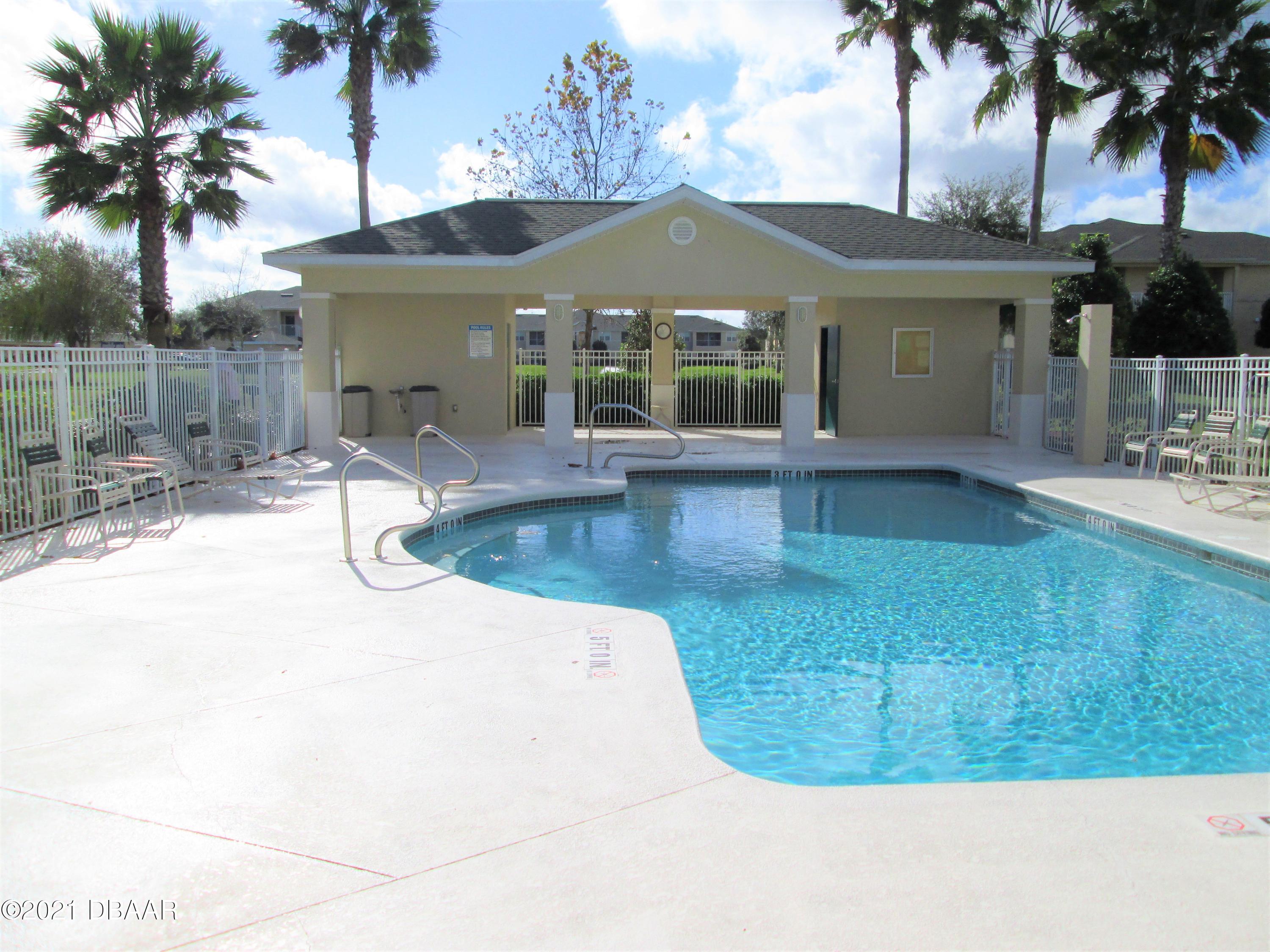 830 Airport Road, Unit 711 Port Orange, FL 32128 - Photo 11 of 47 a view of a house with a swimming pool