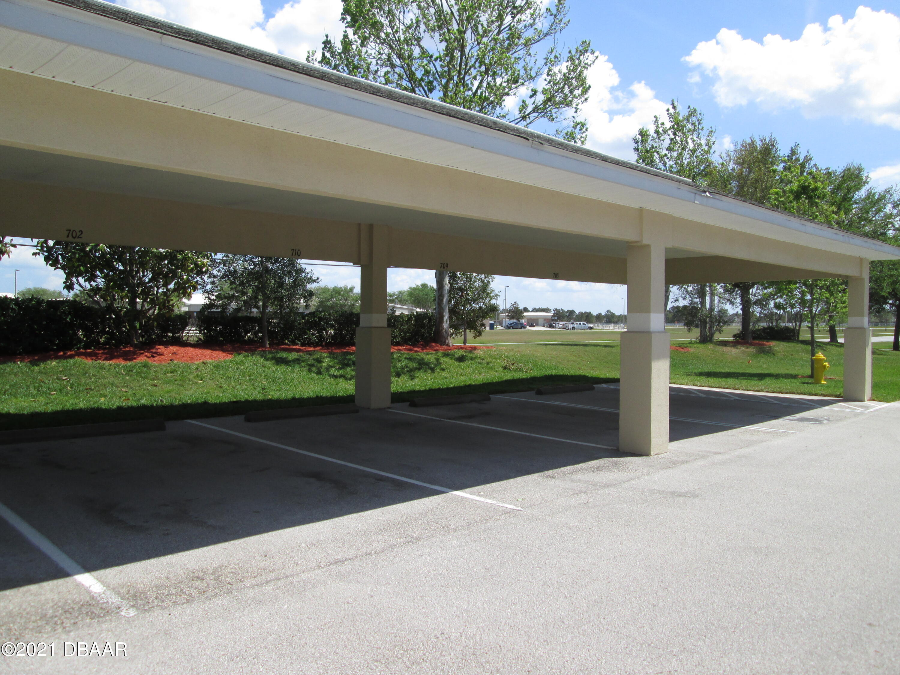 830 Airport Road, Unit 711 Port Orange, FL 32128 - Photo 15 of 47 a view of a patio with a yard