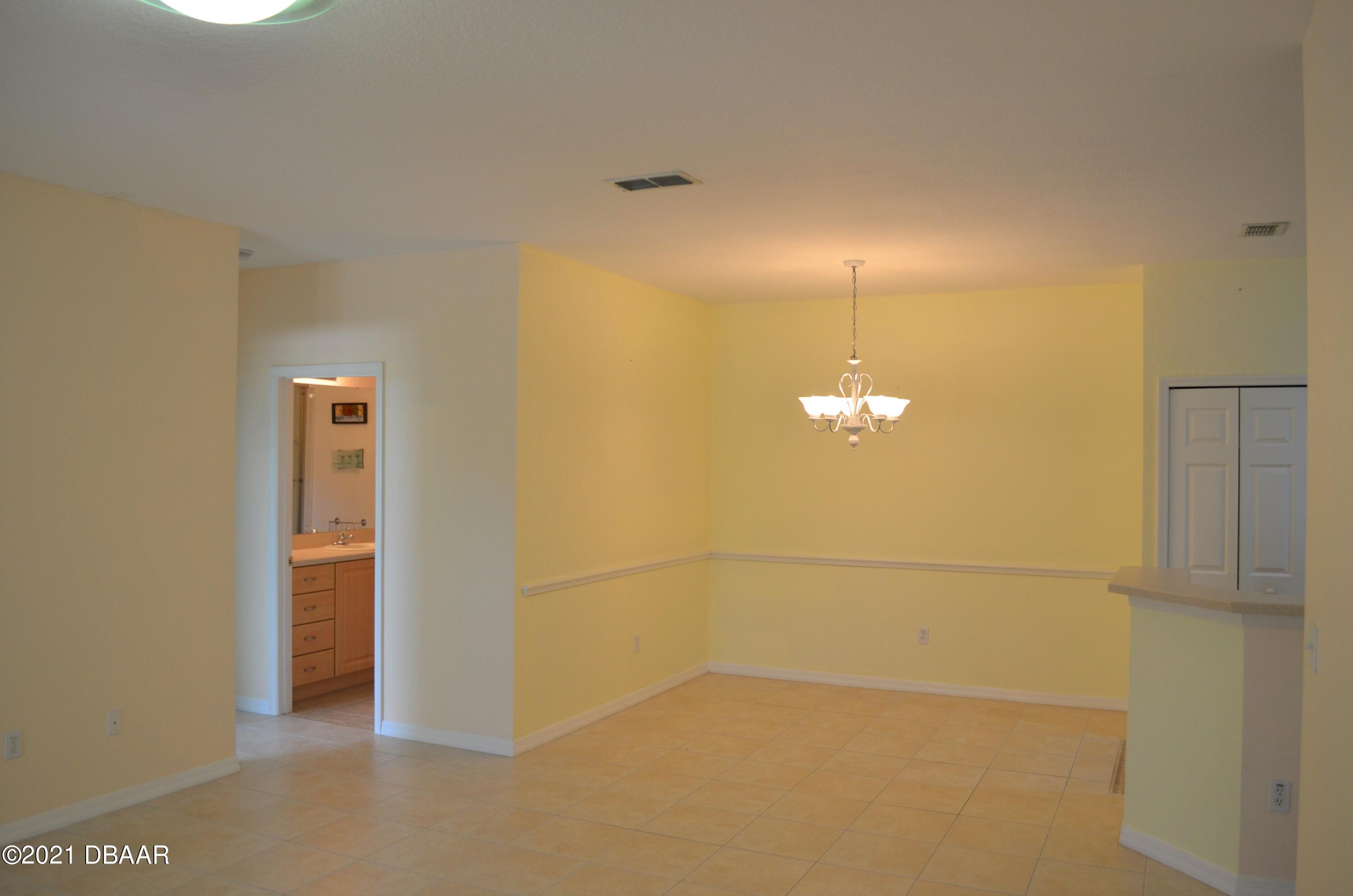 830 Airport Road, Unit 711 Port Orange, FL 32128 - Photo 21 of 47 a view of a refrigerator in a kitchen