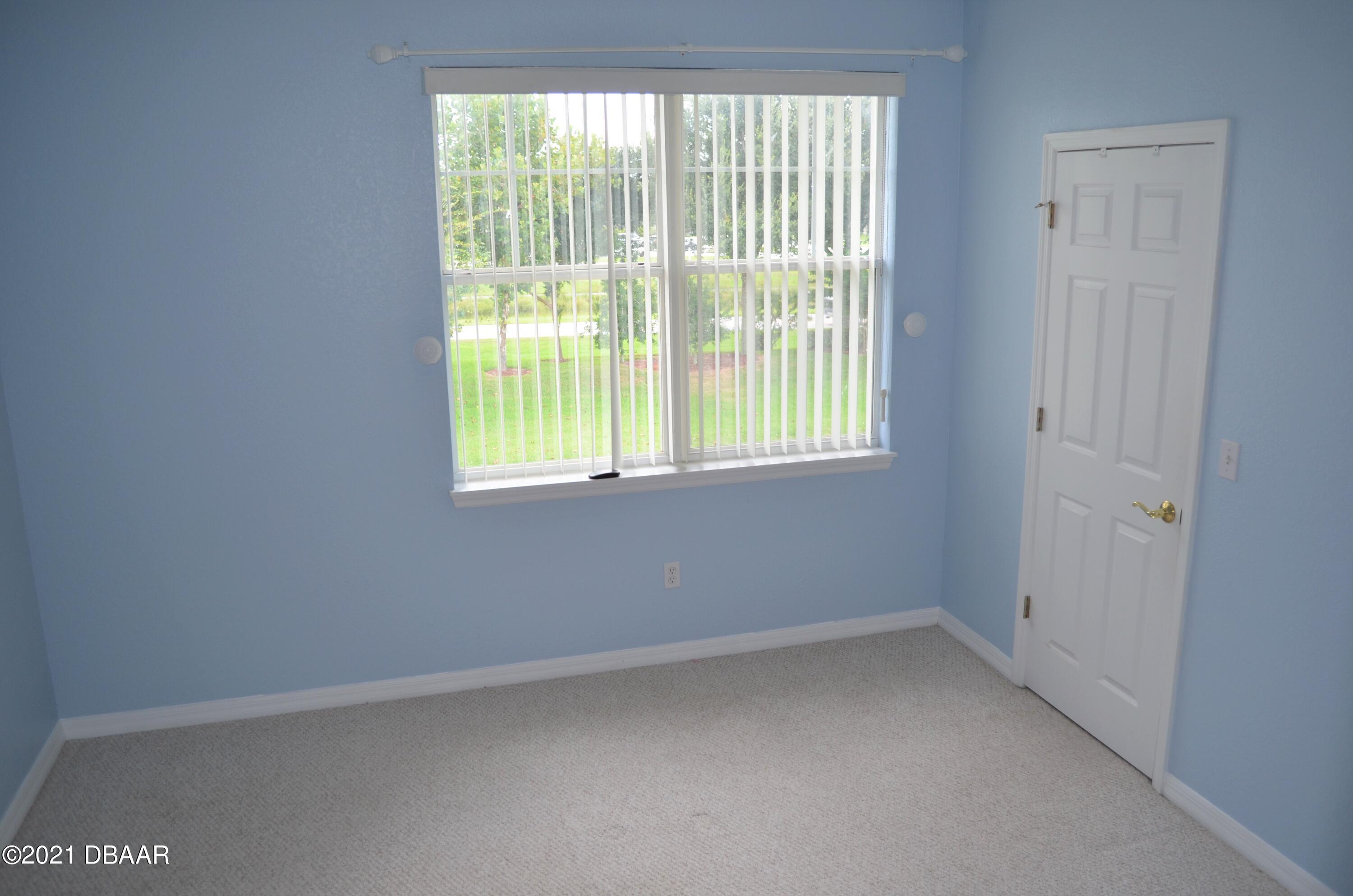 830 Airport Road, Unit 711 Port Orange, FL 32128 - Photo 29 of 47 an empty room with a window
