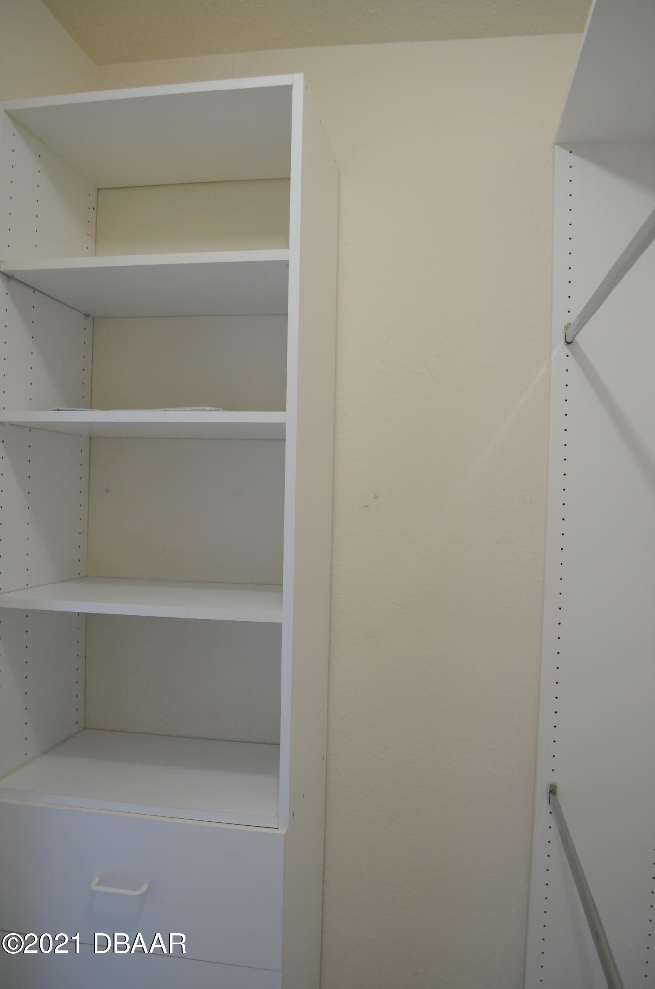 830 Airport Road, Unit 711 Port Orange, FL 32128 - Photo 33 of 47 a view of walk in closet with empty racks