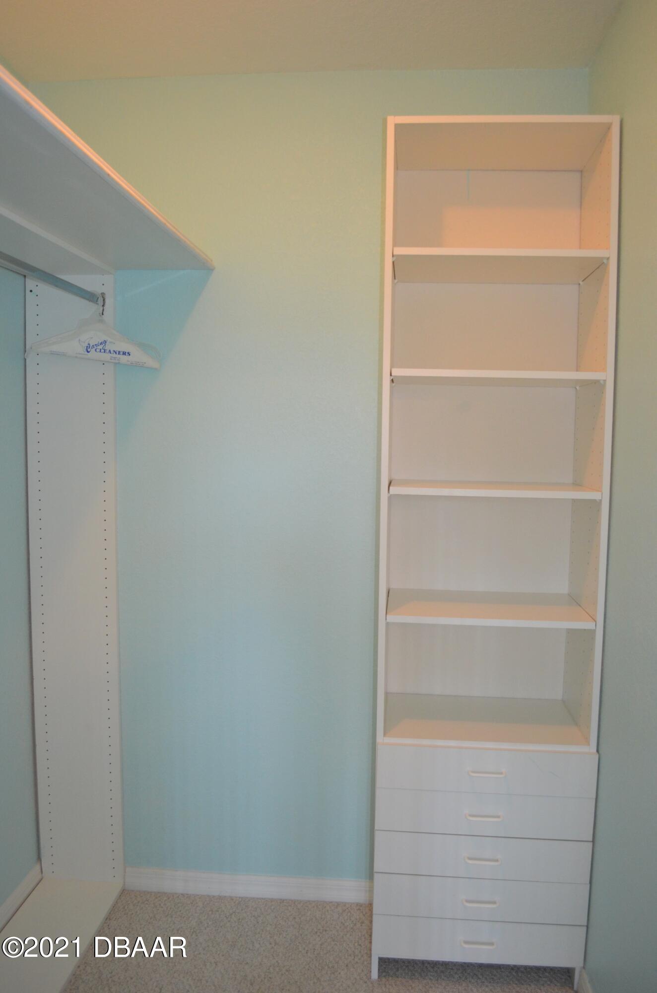 830 Airport Road, Unit 711 Port Orange, FL 32128 - Photo 40 of 47 a view of walk in closet with empty racks