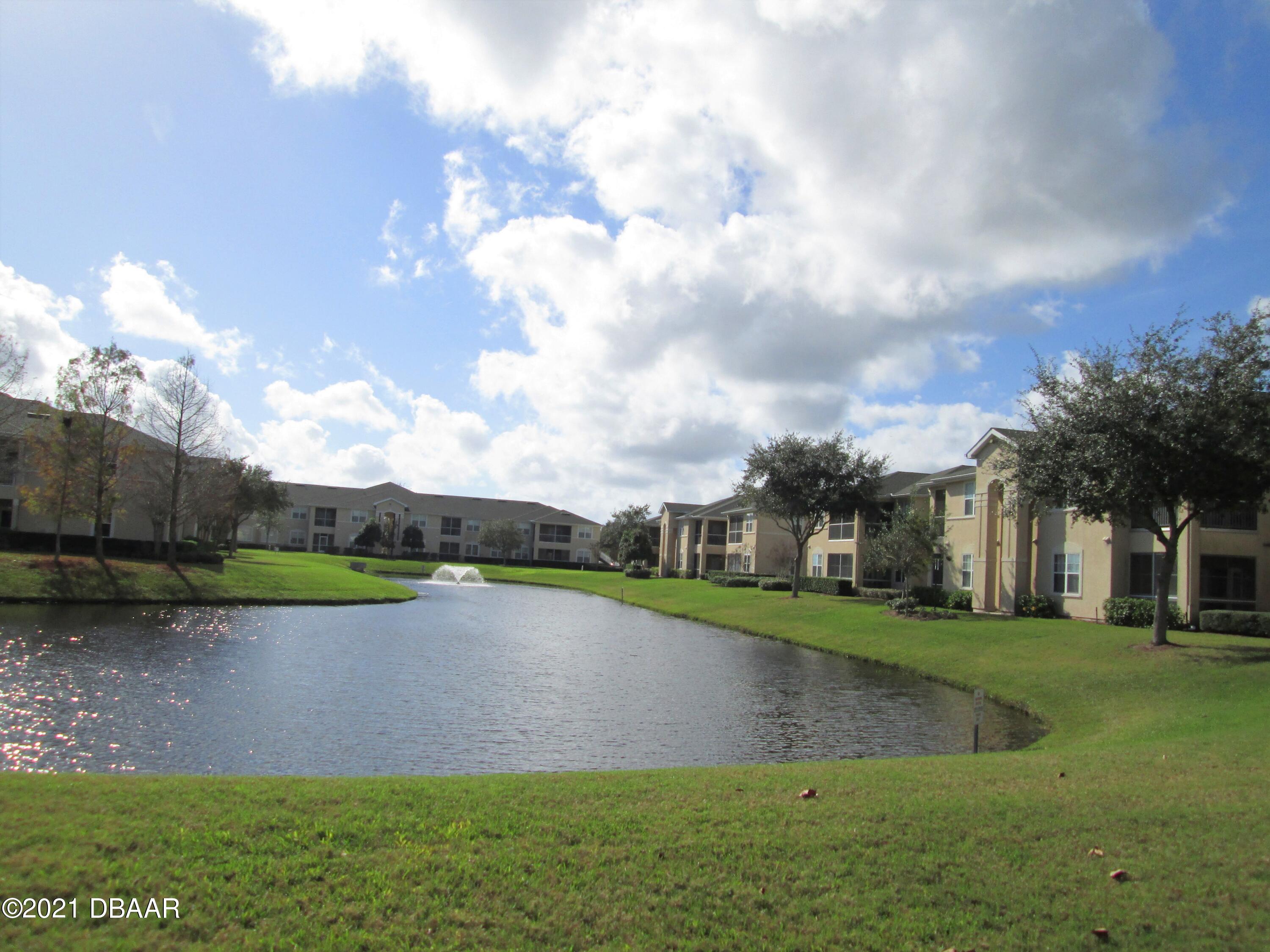 830 Airport Road, Unit 711 Port Orange, FL 32128 - Photo 45 of 47 a view of a lake with a big yard