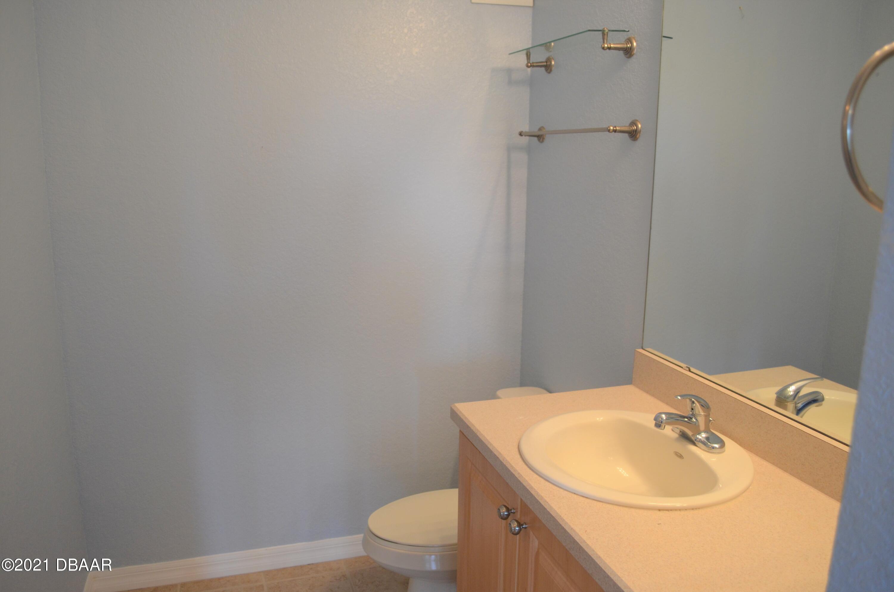 830 Airport Road, Unit 711 Port Orange, FL 32128 - Photo 7 of 47 a bathroom with a sink toilet and a mirror