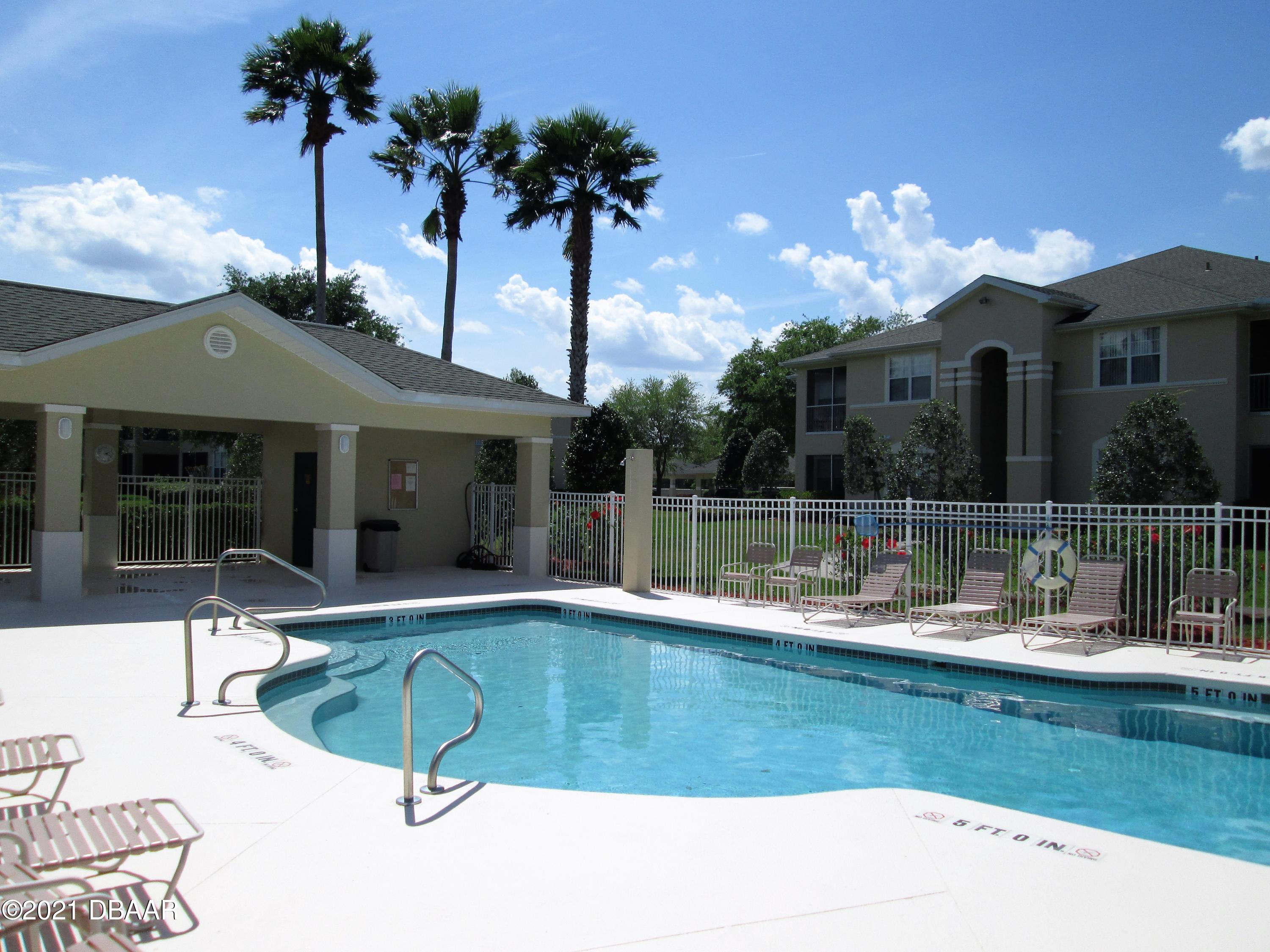 830 Airport Road, Unit 711 Port Orange, FL 32128 - Photo 10 of 47 a view of a house with swimming pool and a porch