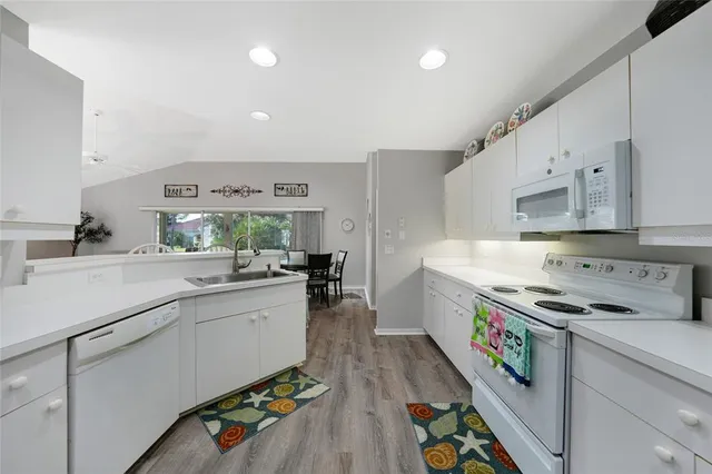 a kitchen with a sink appliances and cabinets