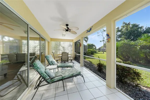 a living room with patio furniture and garden view