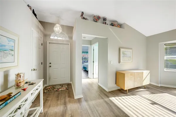 a view of a bedroom with wooden floor and a window