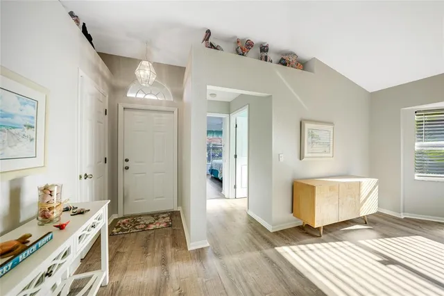 a view of a bedroom with wooden floor and a window