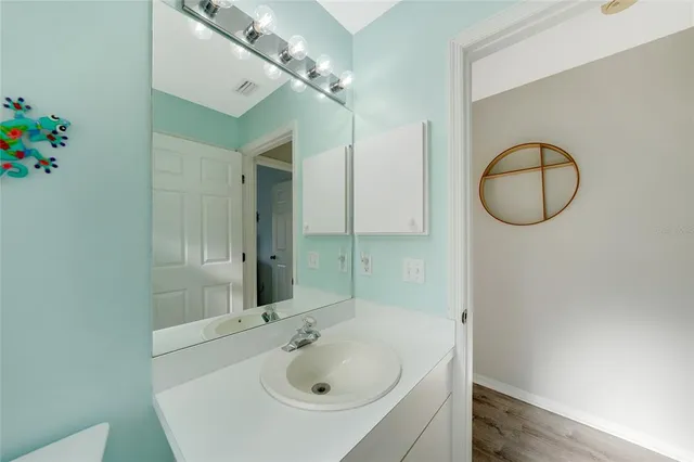 a bathroom with a sink a vanity and a mirror