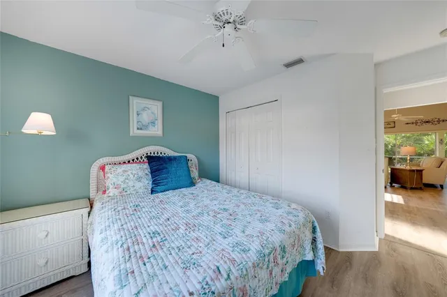 a bedroom with a large bed and a chandelier