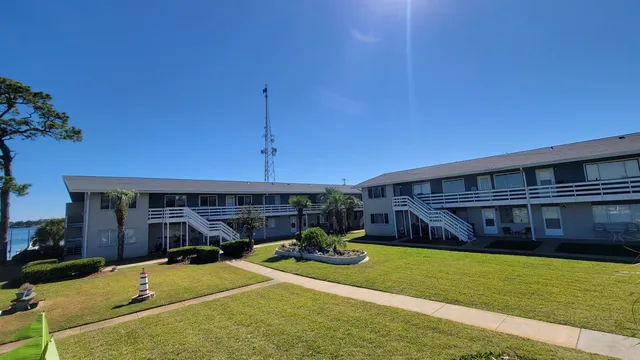 a view of a house with a backyard patio and swimming pool