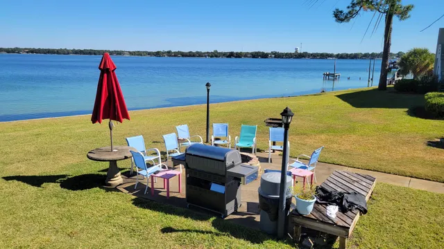 a view of a lake with couches chairs