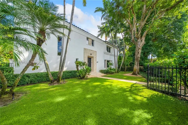 a view of backyard of house with green space