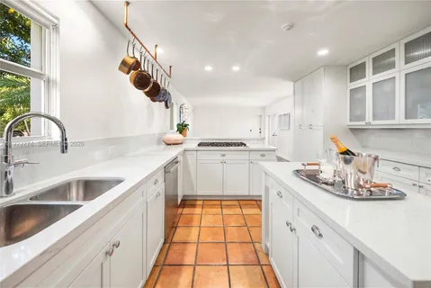 a view of a dining room with furniture and a chandelier