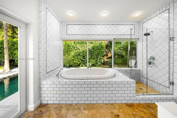 a bedroom with wooden floor closet and a bathroom