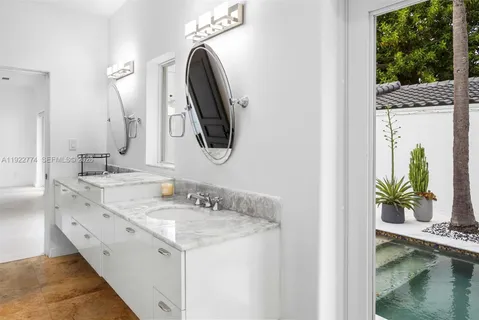 a bedroom with a large bed and a wooden floor