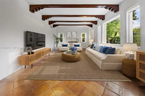 a living room with lots of furniture and a chandelier