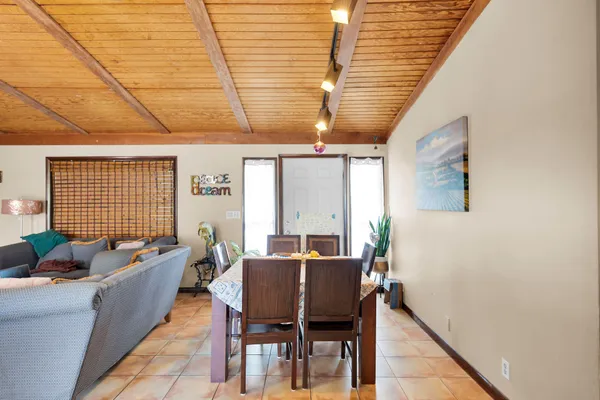 a dining room with furniture and window