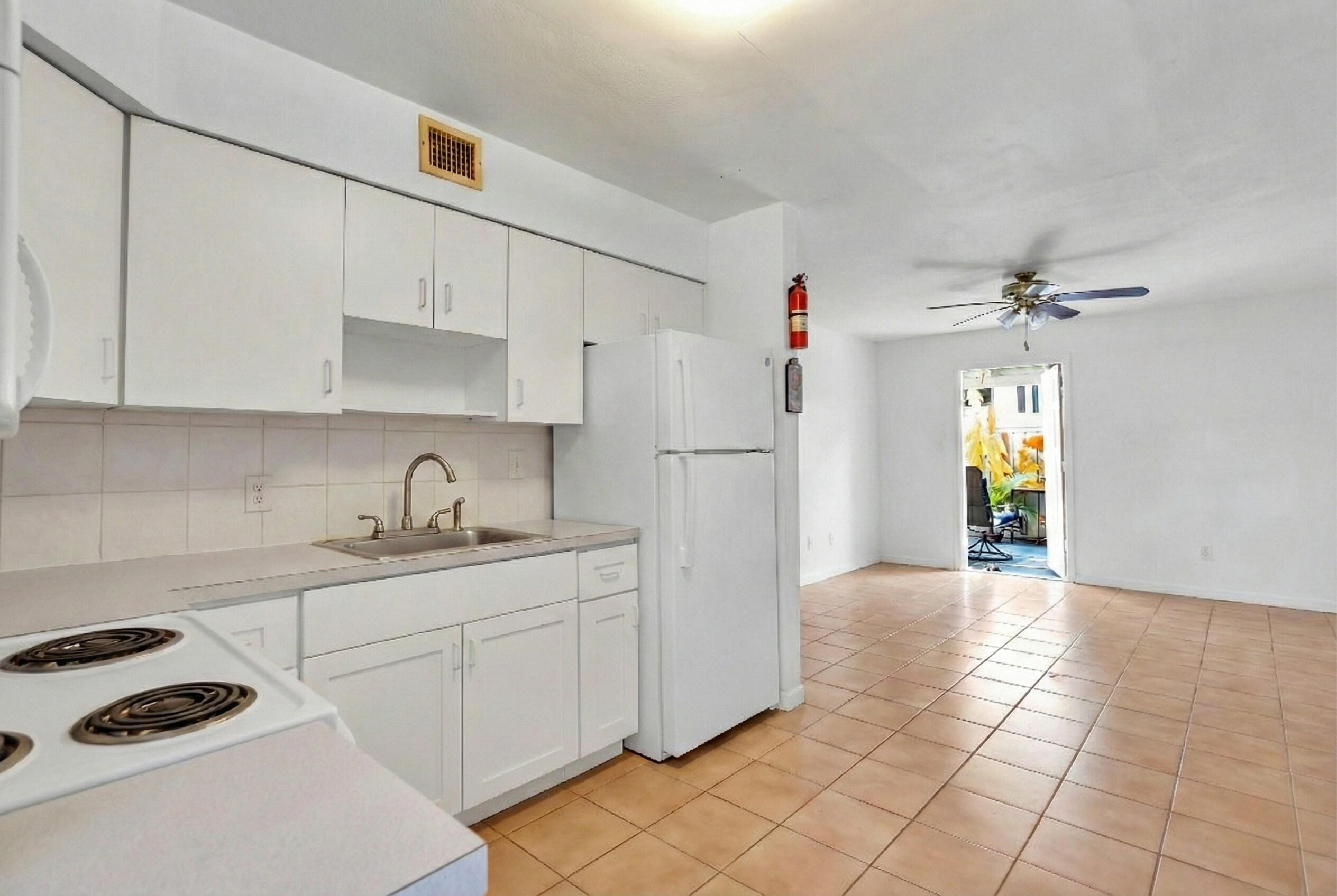 1614 Dennis Street Key West, FL 33040 - Photo 14 of 59 a kitchen with a sink a refrigerator and cabinets