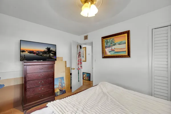 a bed room with a bed and a chandelier