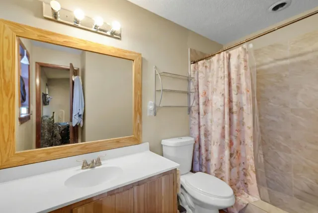a view of a patio with table and chairs potted plants and wooden fence