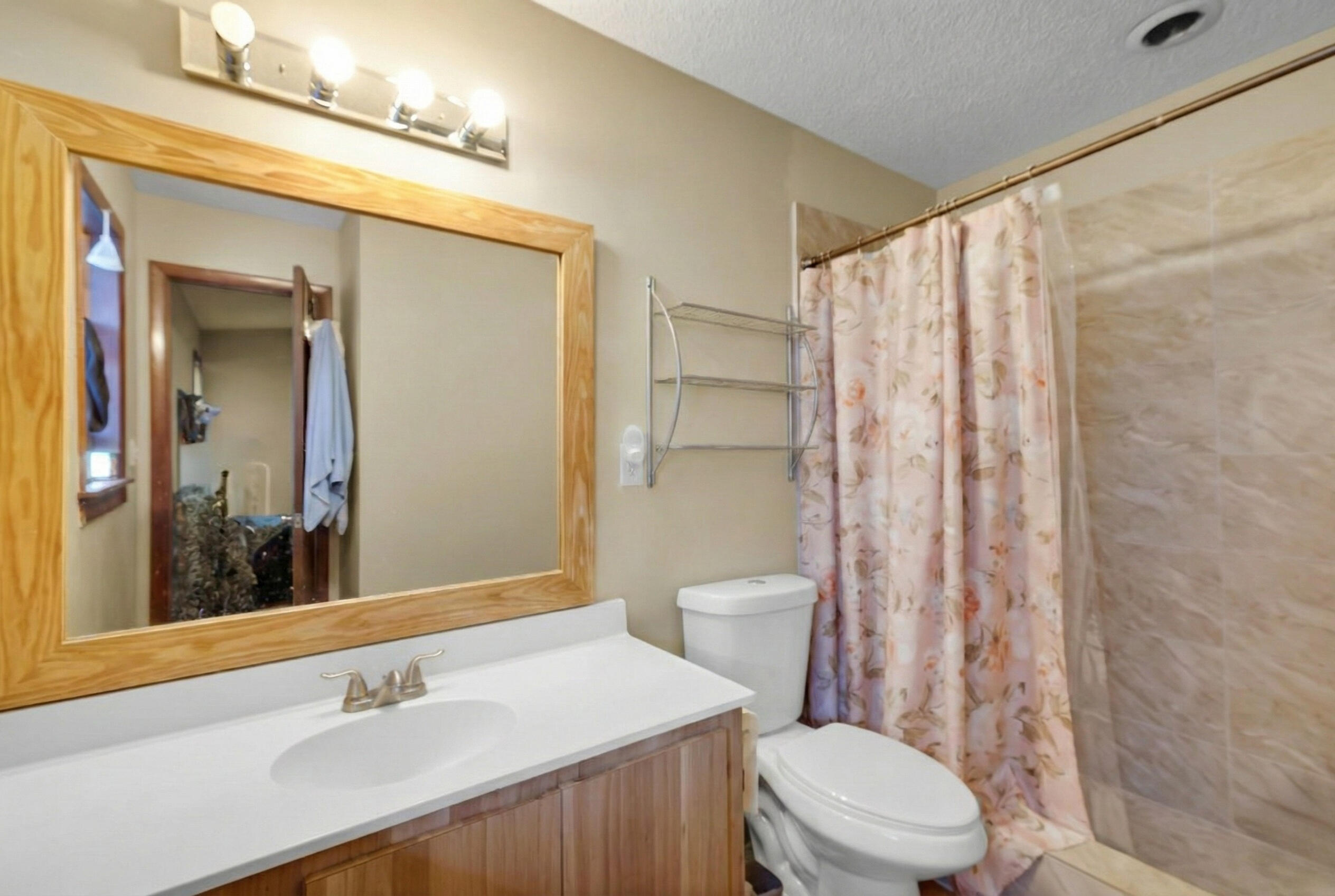 1614 Dennis Street Key West, FL 33040 - Photo 22 of 59 a bathroom with a sink a toilet a mirror and shower curtain