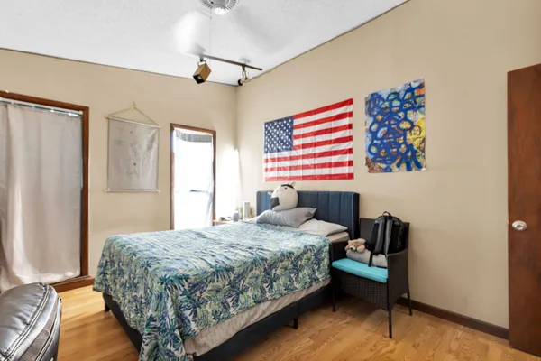 a bedroom with a bed and a chandelier