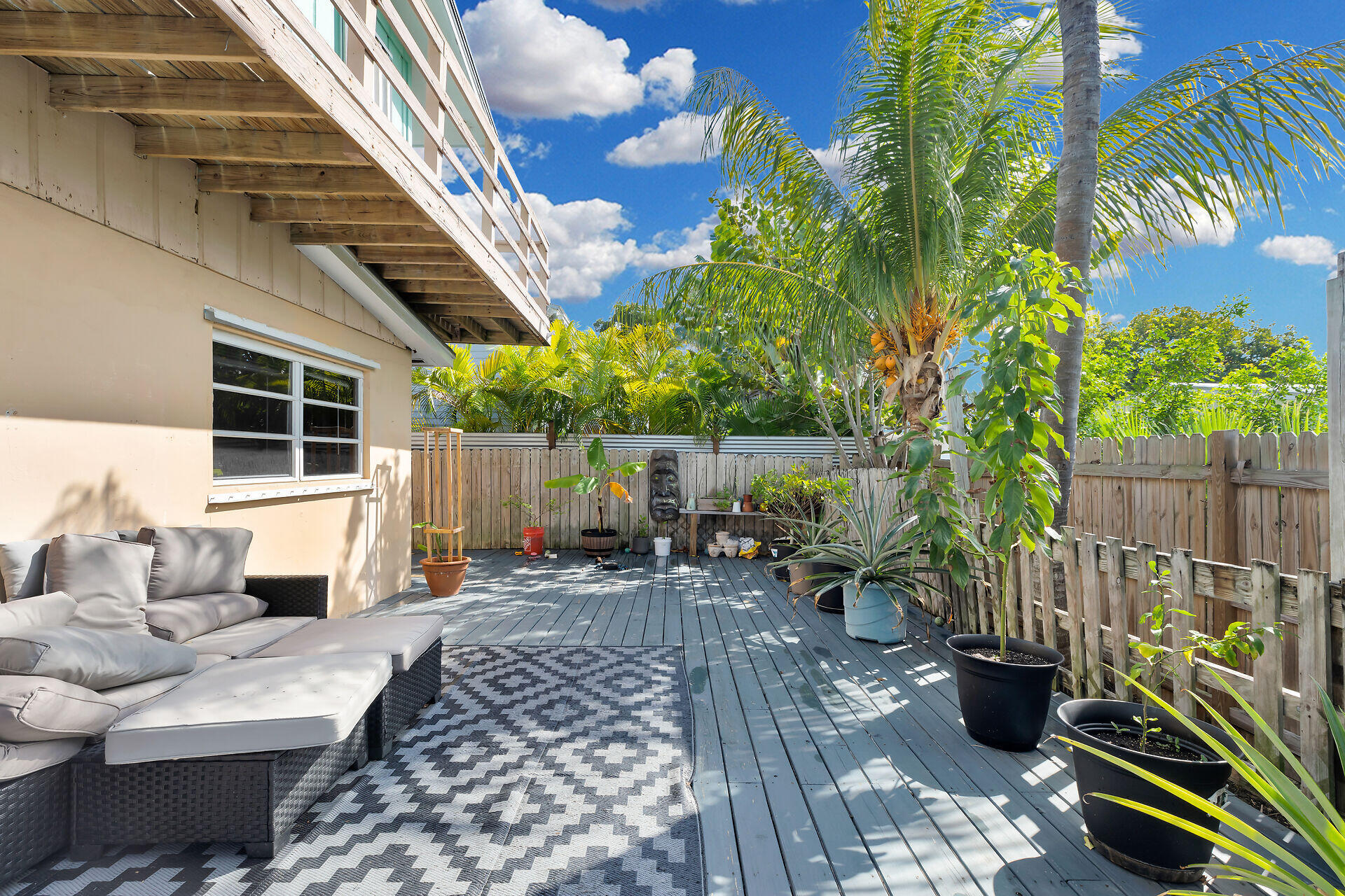 1614 Dennis Street Key West, FL 33040 - Photo 35 of 59 a view of a patio with table and chairs potted plants and wooden fence
