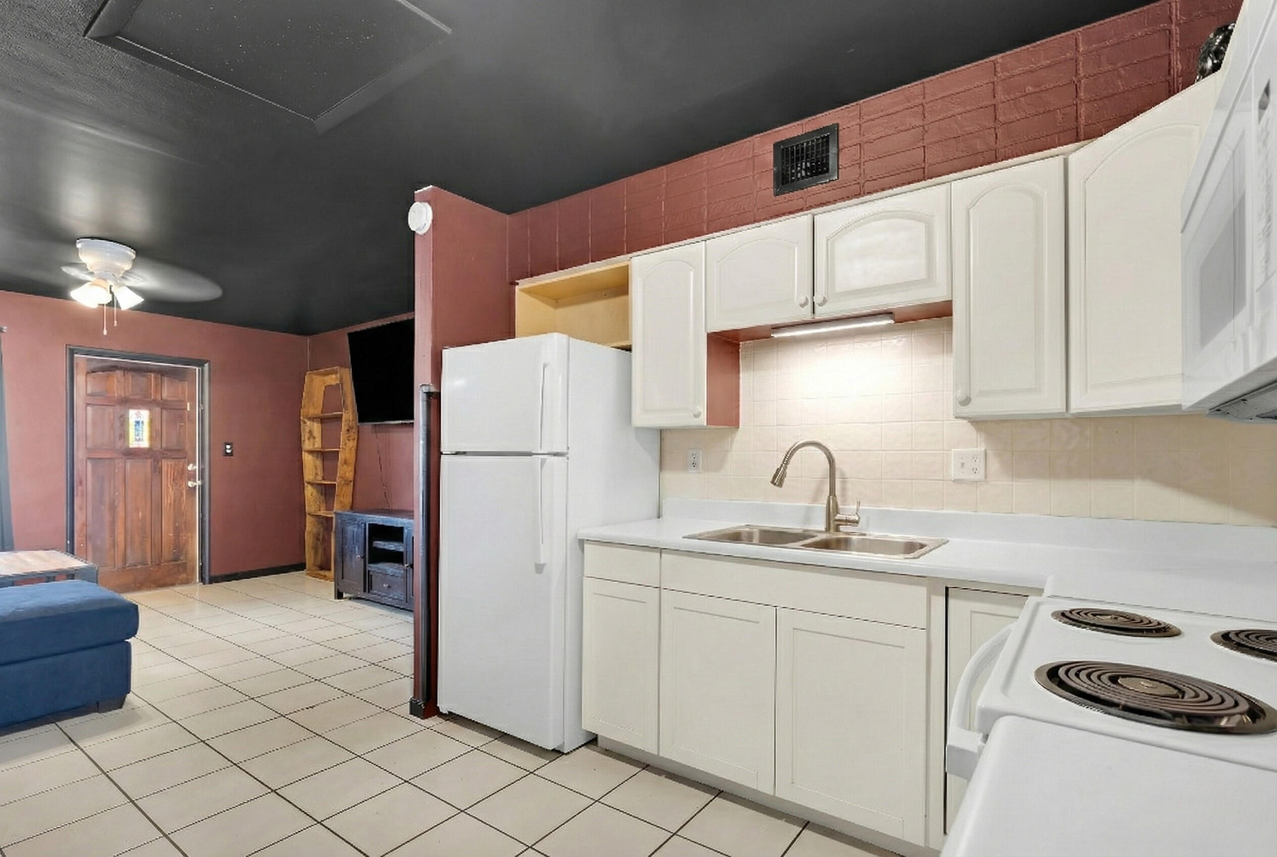 1614 Dennis Street Key West, FL 33040 - Photo 4 of 59 a kitchen with a sink a refrigerator and cabinets