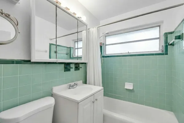 a kitchen with a refrigerator a stove top oven a sink dishwasher and white cabinets next to a window