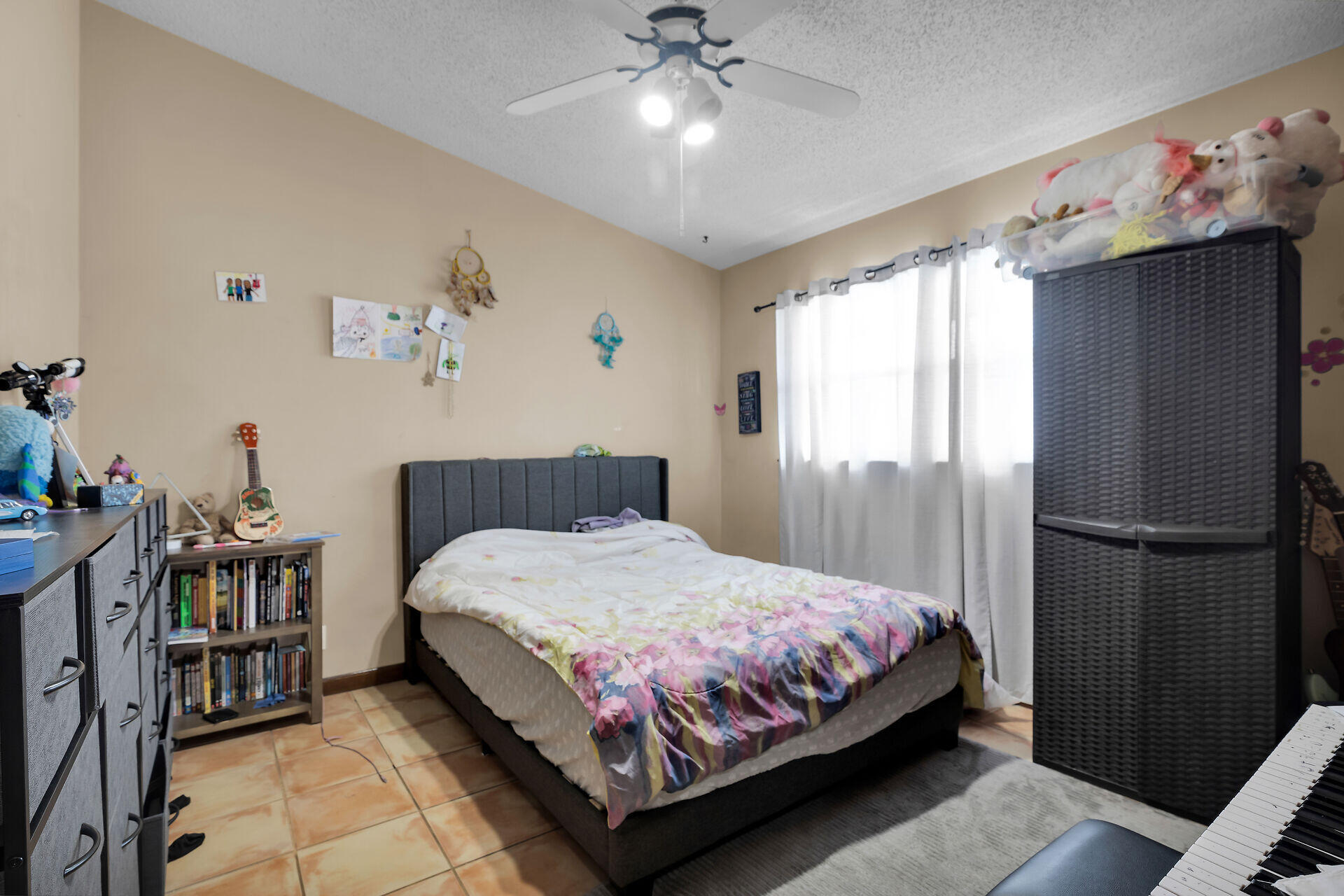 1614 Dennis Street Key West, FL 33040 - Photo 54 of 59 a bedroom with a bed and a chandelier