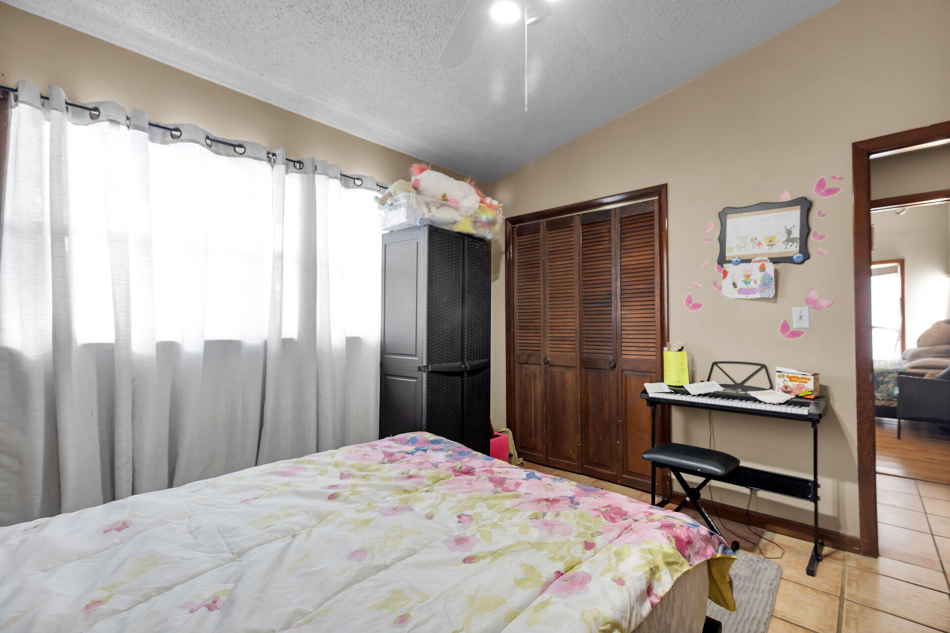 1614 Dennis Street Key West, FL 33040 - Photo 55 of 59 a bedroom with a bed and a chandelier