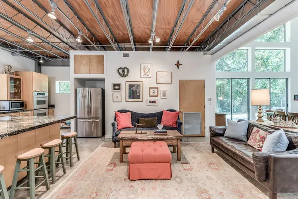 a living room with lots of furniture and a wooden floor