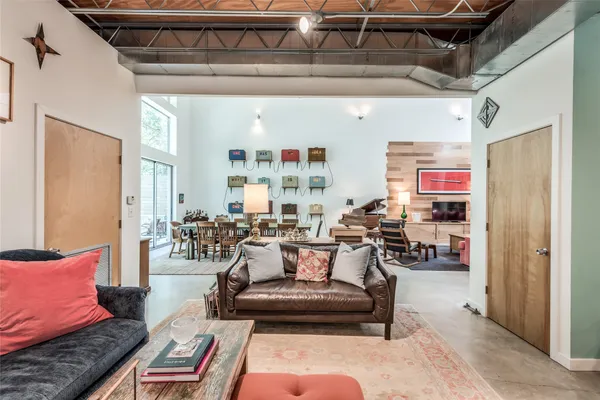 a living room with furniture a large window and a fireplace