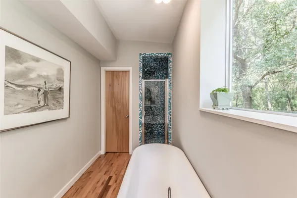 a bedroom with two bed and a window