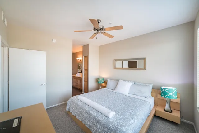 a bedroom with a bed and ceiling fan