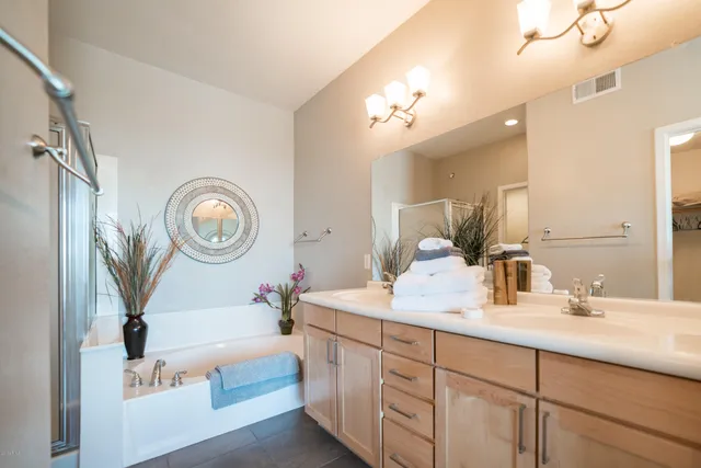 a bathroom with a double vanity sink and a mirror