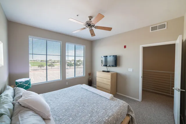 a bed room with a bed and a television