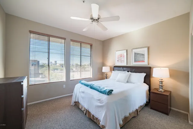 a bed room with a bed and a chandelier