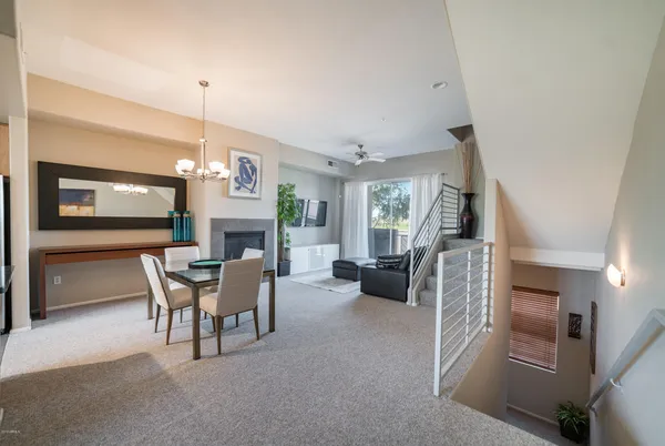 a view of a livingroom with furniture flat screen tv and outdoor view