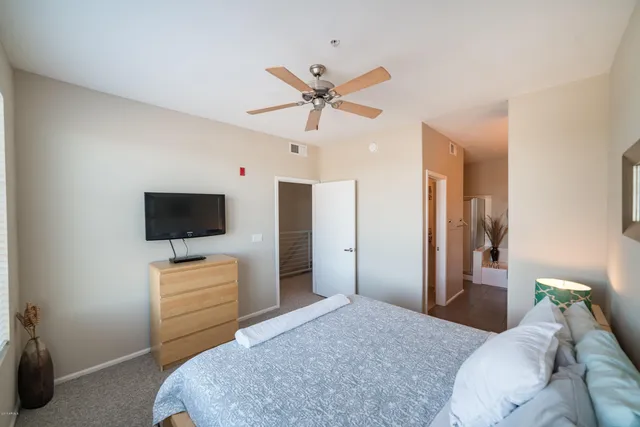 a bedroom with a bed and a flat screen tv