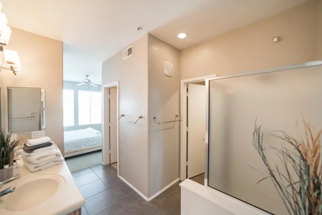 a en suite bathroom with a shower and a double vanity sink