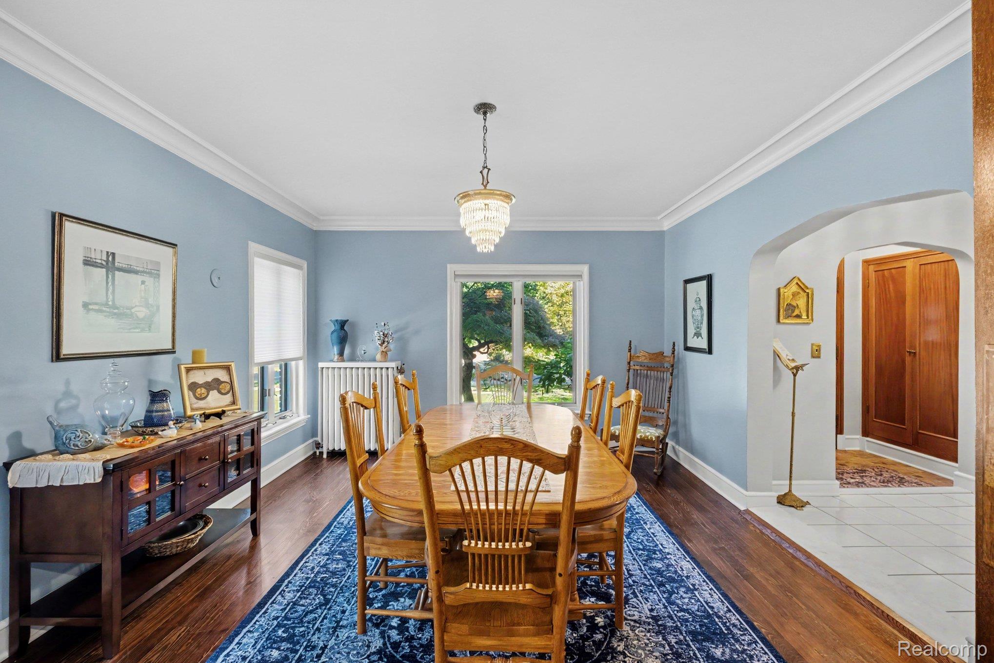 2030 Hampden Road Flint, MI 48503 - Photo 11 of 34 Hardwood flooring, crown molding, white trim, recessed window, and an arched doorway